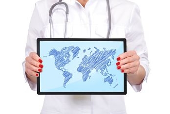 hand female doctor holding touch pad with world map
