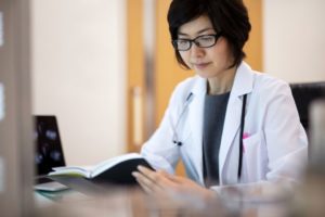 Doctor reading study at desk