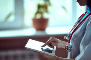 Doctor working on a digital tablet