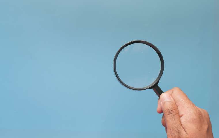 Hand with magnifying glass