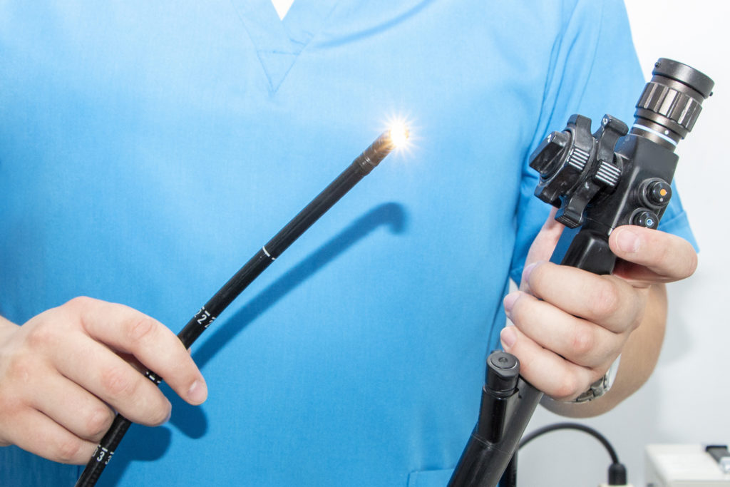Endoscopy at the hospital. Doctor holding endoscope before gastroscopy. Medical examination