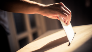 Person putting ballot into box