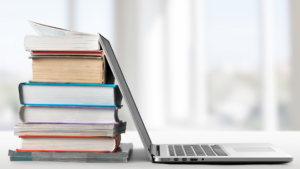 Image of open laptop and textbooks on a table, displaying fellows and early career resources