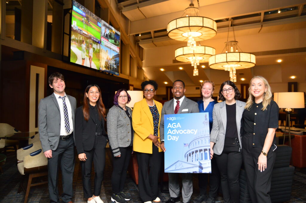 Patient advocates pose while holding the Advocacy Day sign.