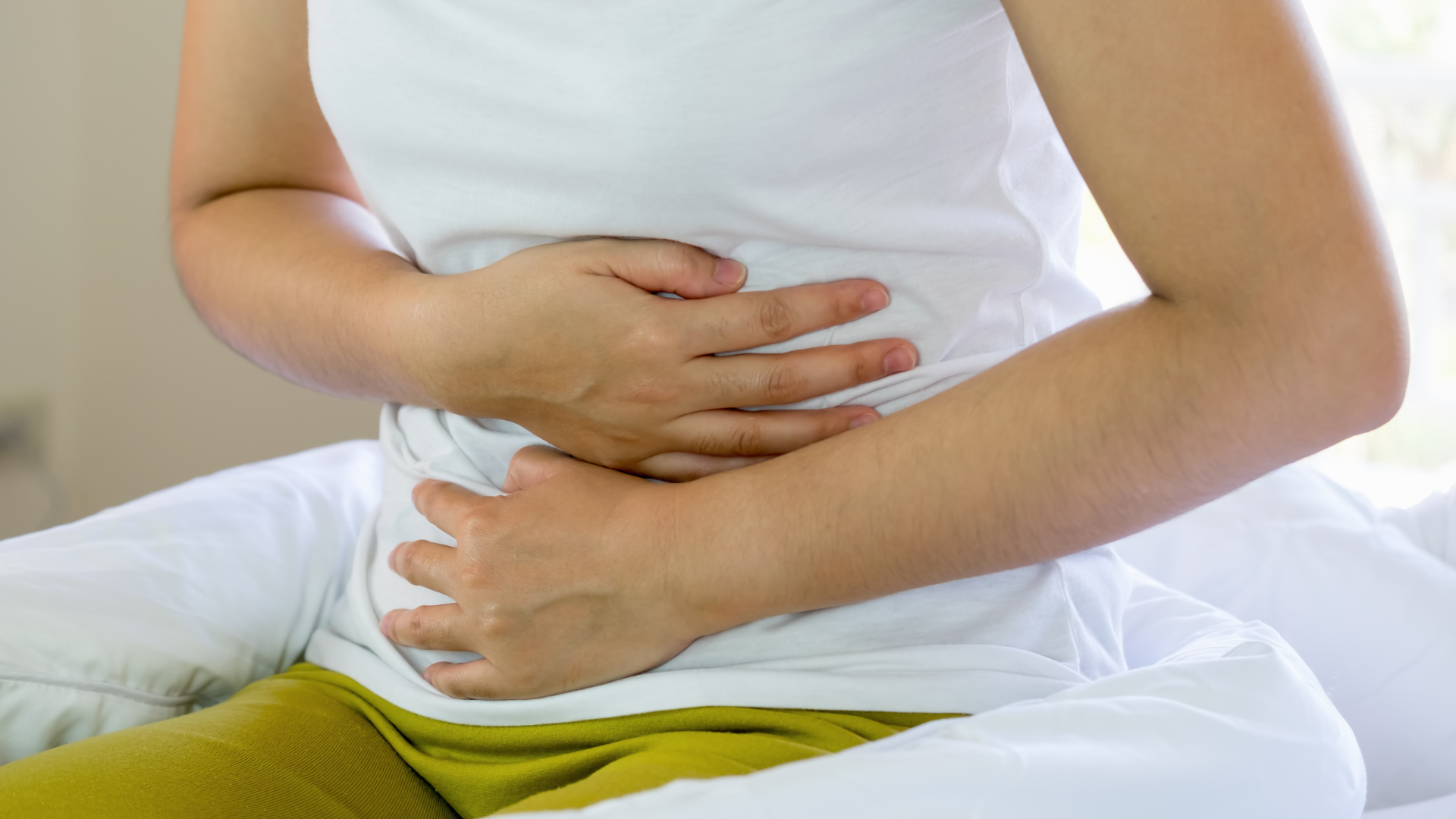 Person holding stomach.