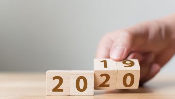 New year 2019 change to 2020 concept. Hand flip over wood cube block New year 2019 change to 2020 concept. Hand flip over wood cube block