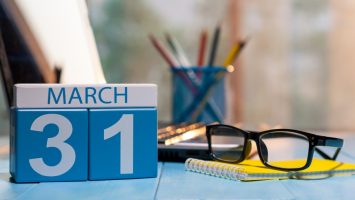 March 31st. Day 31 of month, calendar on business office March 31st. Day 31 of month, calendar on business office background, workplace with laptop and glasses. Spring time, empty space for text.