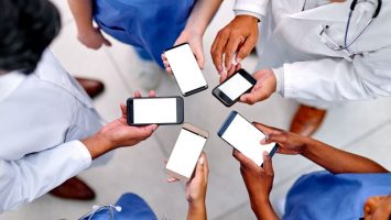High angle shot of a group of medical practitioners using their cellphones in synchronicity