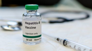 Fake hepatitis B vaccine vial with syringe and stethoscope at the background