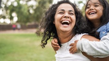 Happy indian mother having fun with her daughter outdoor – Family and love concept – Focus on mum face Moms in medicine