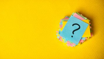 question marks written reminders tickets on yellow vintage paper background question marks written reminders tickets on yellow vintage paper background.