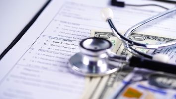 Health insurance accident claim form with stethoscope and US dollar banknotes, Medical concept. Health insurance accident claim form with stethoscope and US dollar banknotes, Medical concept.