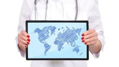 hand female doctor holding touch pad with world map