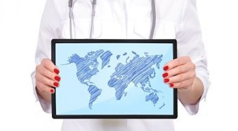 hand female doctor holding touch pad with world map