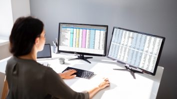 Businesswoman Working On Computer Side View Of Businesswoman's Hand Analyzing Data On Computer Over Desk
